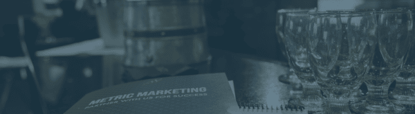 A Metric Marketing booklet resting on a table.