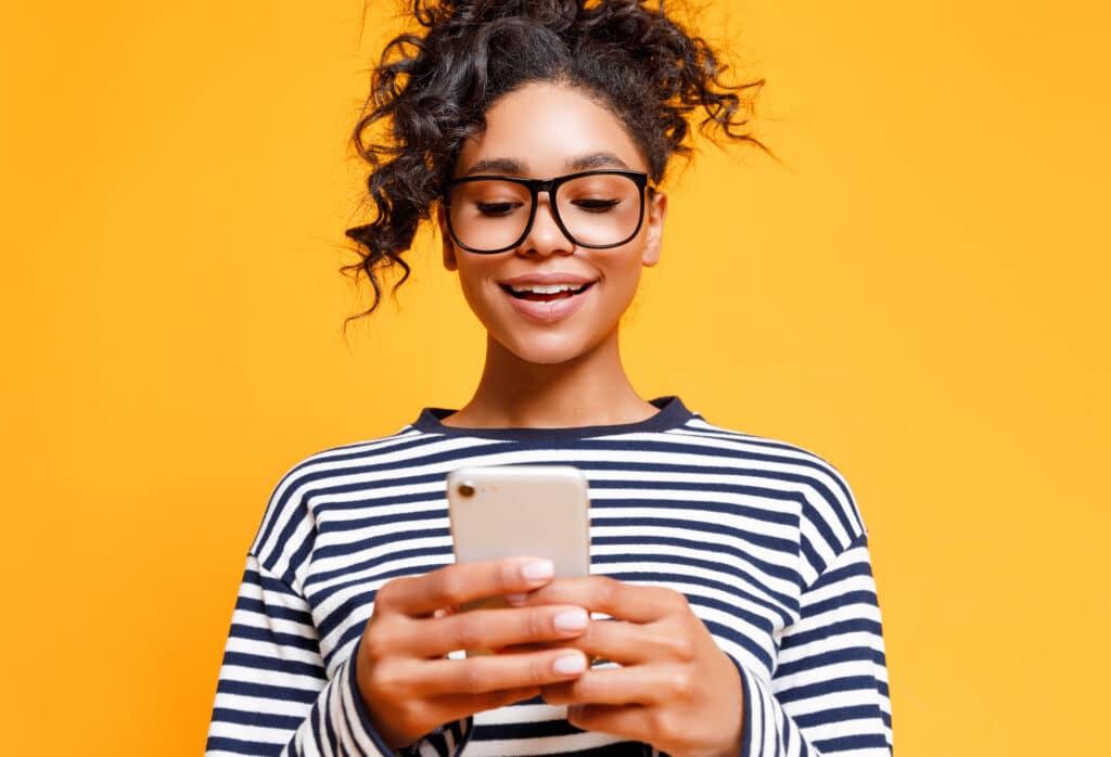 Young ethnic woman using smartphone