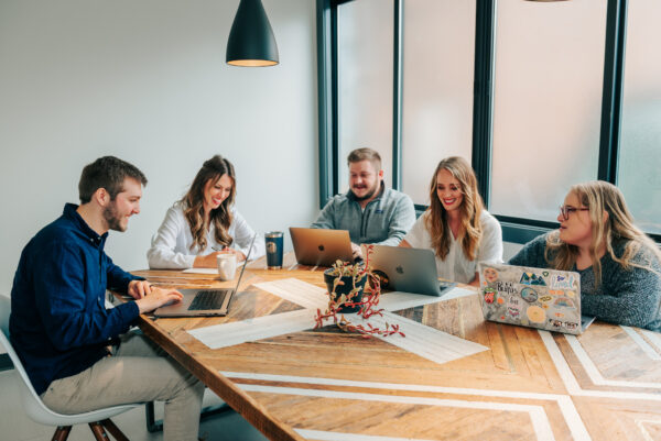 Metric marketing team brainstorming at a conference table