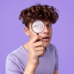 Young detective looking at camera