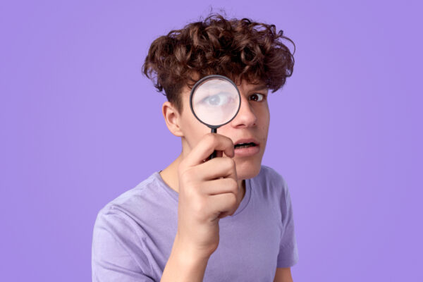 Young detective looking at camera