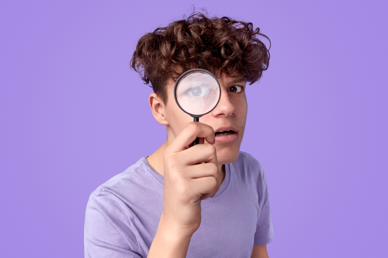 Young detective looking at camera
