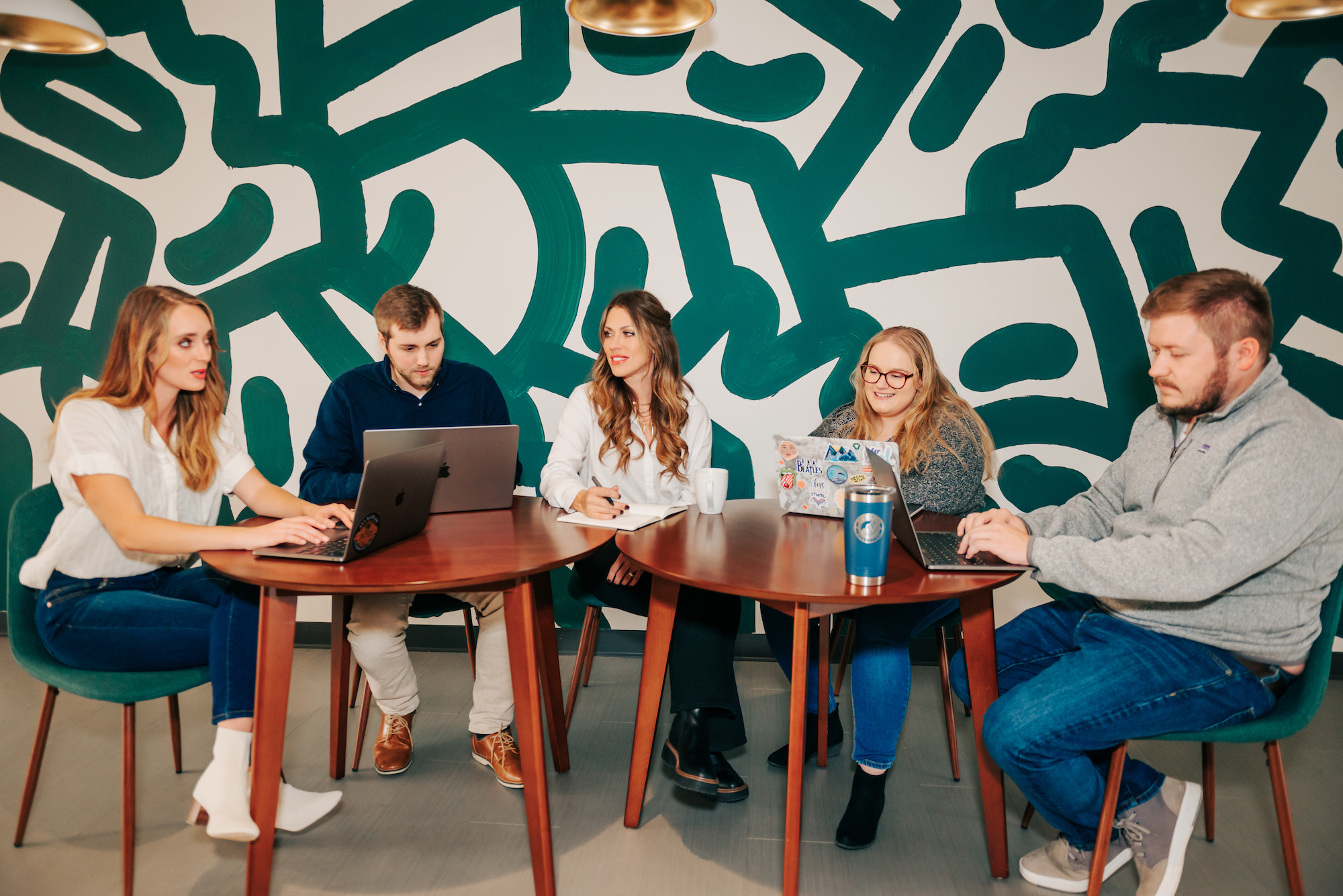 Metric Marketing team in a brainstorm session sitting at tables