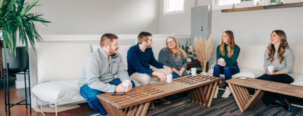 Metric Marketing team in a brainstorming session drinking coffee