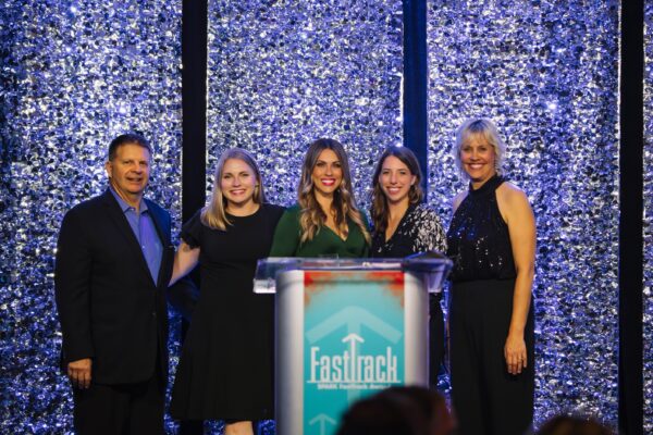 Metric Marketing Team on Stage Receiving a FastTrack Award From Ann Arbor SPARK